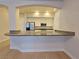 Kitchen with granite countertop bar area, stainless steel appliances, and ample cabinet space at 38 E Serene Ave # 432, Las Vegas, NV 89123