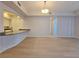 Living room view showing the light wood flooring and open design to the kitchen area at 38 E Serene Ave # 432, Las Vegas, NV 89123