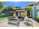 Community outdoor kitchen area features stainless steel grill, sink, countertop, and umbrella-covered seating at 38 E Serene Ave # 432, Las Vegas, NV 89123