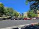 Exterior view of the parking lot in front of the apartment complex on a clear day at 38 E Serene Ave # 432, Las Vegas, NV 89123