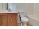 Cozy bathroom featuring wood cabinets, white sink, toilet and bath with shower at 3920 Smokey Fog Ave # 201, North Las Vegas, NV 89081