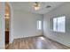 A light-filled bedroom with hardwood floors and two windows showing off the outdoor view at 3920 Smokey Fog Ave # 201, North Las Vegas, NV 89081