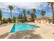 Inviting community pool with palm trees and lounge chairs under a bright sky at 3920 Smokey Fog Ave # 201, North Las Vegas, NV 89081