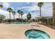 Stunning pool area with palm trees, lounge chairs, hot tub and sunny skies at 3920 Smokey Fog Ave # 201, North Las Vegas, NV 89081