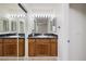Bathroom with dark vanity, vanity mirror, and sliding mirrored doors at 3972 Tirana Way, Las Vegas, NV 89103