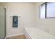 Bright bathroom features a bathtub with jets, neutral wall and tile, and a towel bar at 3972 Tirana Way, Las Vegas, NV 89103