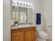 Bright bathroom features a wood vanity with a stone countertop and a matching framed mirror at 3972 Tirana Way, Las Vegas, NV 89103