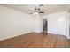 Minimalist bedroom with hardwood floors, neutral walls, and a ceiling fan with lighting at 3972 Tirana Way, Las Vegas, NV 89103
