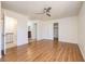Spacious bedroom with hardwood flooring, ceiling fan, and access to the bathroom and closet at 3972 Tirana Way, Las Vegas, NV 89103