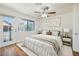 Bedroom with hardwood floors, ceiling fan, and a bright window at 3972 Tirana Way, Las Vegas, NV 89103