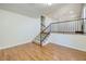 Spacious bonus room with hardwood floors, staircase, and access to other areas of the home at 3972 Tirana Way, Las Vegas, NV 89103