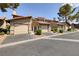 Attractive townhomes with garages and well-manicured landscaping along a peaceful street at 3972 Tirana Way, Las Vegas, NV 89103