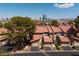 Townhomes with red tile roofs, attached garages and desert landscaping, set against the Las Vegas skyline at 3972 Tirana Way, Las Vegas, NV 89103