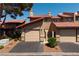 Attractive townhome featuring garages and well-maintained landscaping, enhancing its curb appeal at 3972 Tirana Way, Las Vegas, NV 89103