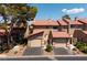 Charming townhome featuring a red tile roof and attached garages, showcasing curb appeal and convenient parking at 3972 Tirana Way, Las Vegas, NV 89103