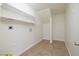 Bright laundry room features a tile floor, utility sink connection, and shelving for storage at 3972 Tirana Way, Las Vegas, NV 89103