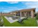 Home featuring a sparkling rectangular pool and artificial grass at 398 Frank Case Ln, Henderson, NV 89011