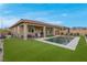 Home featuring a sparkling rectangular pool, artificial grass and covered patio at 398 Frank Case Ln, Henderson, NV 89011