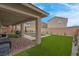Home featuring a sparkling rectangular pool, artificial grass and covered patio at 398 Frank Case Ln, Henderson, NV 89011
