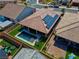 Aerial view of backyard with pool, artificial turf, seating area, solar panels and covered patio at 398 Frank Case Ln, Henderson, NV 89011