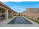Home featuring a sparkling rectangular pool, artificial grass and covered patio at 398 Frank Case Ln, Henderson, NV 89011