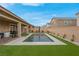 Home featuring a sparkling rectangular pool, artificial grass and covered patio at 398 Frank Case Ln, Henderson, NV 89011
