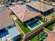 Aerial view of backyard with pool, artificial turf, seating area, solar panels and covered patio at 398 Frank Case Ln, Henderson, NV 89011