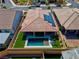 Aerial view of backyard with pool, artificial turf, seating area, solar panels and covered patio at 398 Frank Case Ln, Henderson, NV 89011