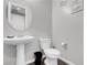 Stylish half bathroom featuring a pedestal sink, modern fixtures, and fresh decor at 398 Frank Case Ln, Henderson, NV 89011