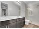Modern bathroom with double vanity, large mirror, and walk-in shower with glass door at 398 Frank Case Ln, Henderson, NV 89011