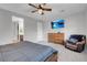 Well-lit bedroom with a ceiling fan, dresser, and comfortable armchair at 398 Frank Case Ln, Henderson, NV 89011