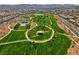 Beautiful aerial view of community park including green space, walking paths, playground and community pool at 398 Frank Case Ln, Henderson, NV 89011