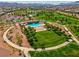 Beautiful aerial view of community pool, walking paths, green space and playground in community park at 398 Frank Case Ln, Henderson, NV 89011