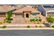 Attractive single-story home featuring a paved driveway, lush landscaping, and a welcoming entrance, enhancing curb appeal at 398 Frank Case Ln, Henderson, NV 89011