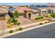 Charming single-story home with a two-car garage, well-kept landscaping, and a paved driveway, adding to its appeal at 398 Frank Case Ln, Henderson, NV 89011