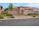 Inviting single-story home with a paver driveway, desert landscaping, and a two-car garage at 398 Frank Case Ln, Henderson, NV 89011
