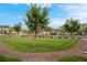 Well-maintained front yard with lush grass, a decorative brick border, and mature shade trees, creating a welcoming entrance at 398 Frank Case Ln, Henderson, NV 89011