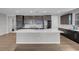 Modern kitchen featuring stainless steel appliances and a large white countertop island at 398 Frank Case Ln, Henderson, NV 89011