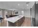 Open concept kitchen island with stainless dishwasher, sink and adjacent living area at 398 Frank Case Ln, Henderson, NV 89011