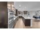 Modern kitchen featuring stainless steel appliances, a large island, and dark wood cabinetry at 398 Frank Case Ln, Henderson, NV 89011