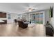 Bright living room with hardwood floors, sliders to the backyard and comfortable leather seating at 398 Frank Case Ln, Henderson, NV 89011