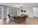 Open-concept living room featuring sliding doors, hardwood flooring, and a large comfortable sofa at 398 Frank Case Ln, Henderson, NV 89011