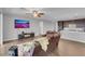 Living room with hardwood floors and adjacent kitchen featuring stainless steel appliances at 398 Frank Case Ln, Henderson, NV 89011