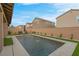 Beautiful backyard pool surrounded by lush landscaping and a brick perimeter wall, providing a private oasis at 398 Frank Case Ln, Henderson, NV 89011