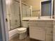 A well-maintained bathroom featuring a shower, toilet, sink, and tile accents at 4013 Extenso Dr, North Las Vegas, NV 89032
