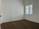 A simple bedroom featuring bright walls, brown carpet and a window with white blinds at 4013 Extenso Dr, North Las Vegas, NV 89032