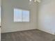A bright bedroom with neutral walls, ceiling fan and brown carpet flooring at 4013 Extenso Dr, North Las Vegas, NV 89032