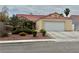 Charming single-story home with a red tile roof, neutral stucco, and well-manicured landscaping at 4013 Extenso Dr, North Las Vegas, NV 89032