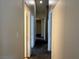 Carpeted hallway with multiple doors and overhead lighting at 4013 Extenso Dr, North Las Vegas, NV 89032