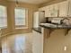 Bright kitchen featuring tile floors, granite countertops, and ample cabinet space at 4013 Extenso Dr, North Las Vegas, NV 89032